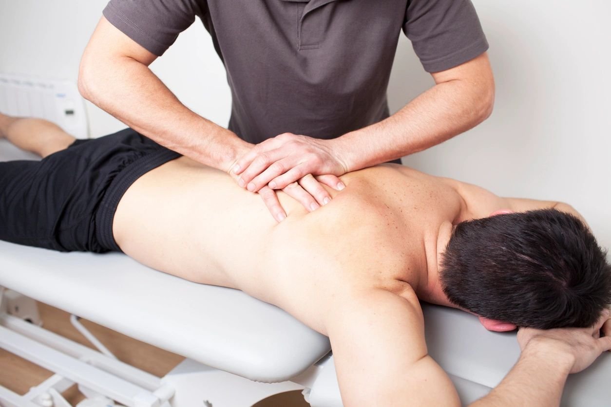 Man receiving a back massage on a table.
